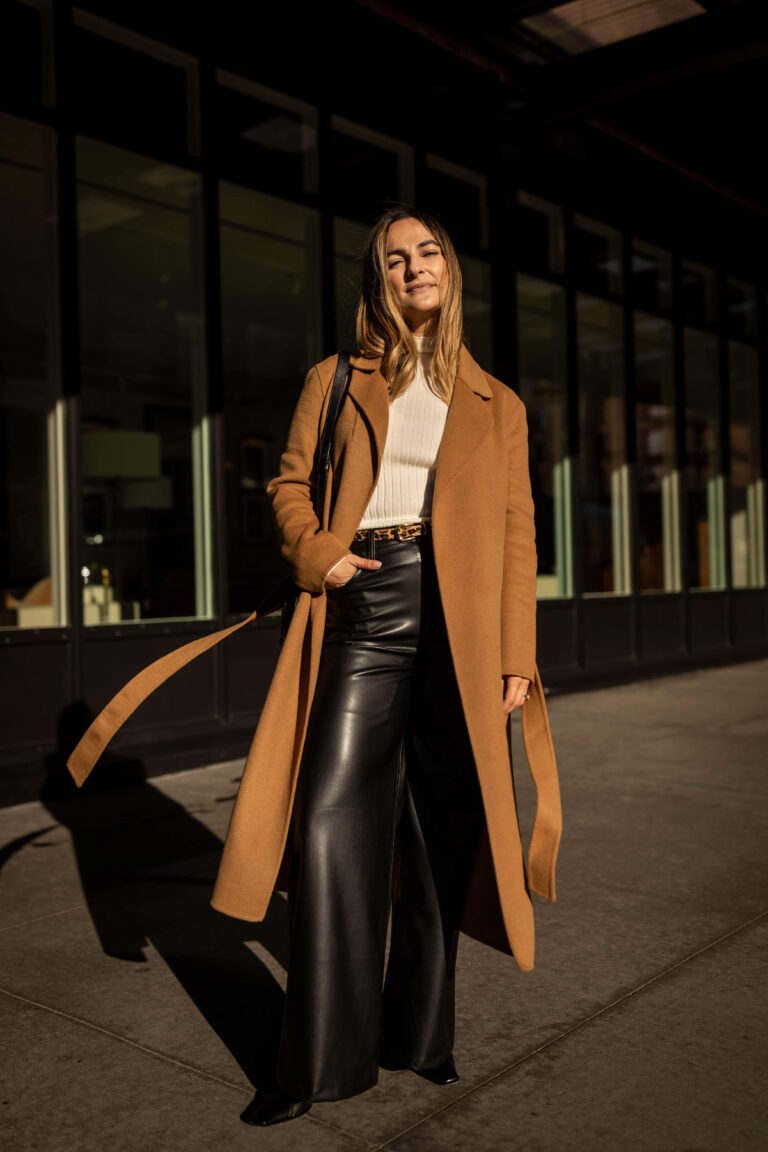 Woman styling wide-leg black leather trousers with a simple fitted top