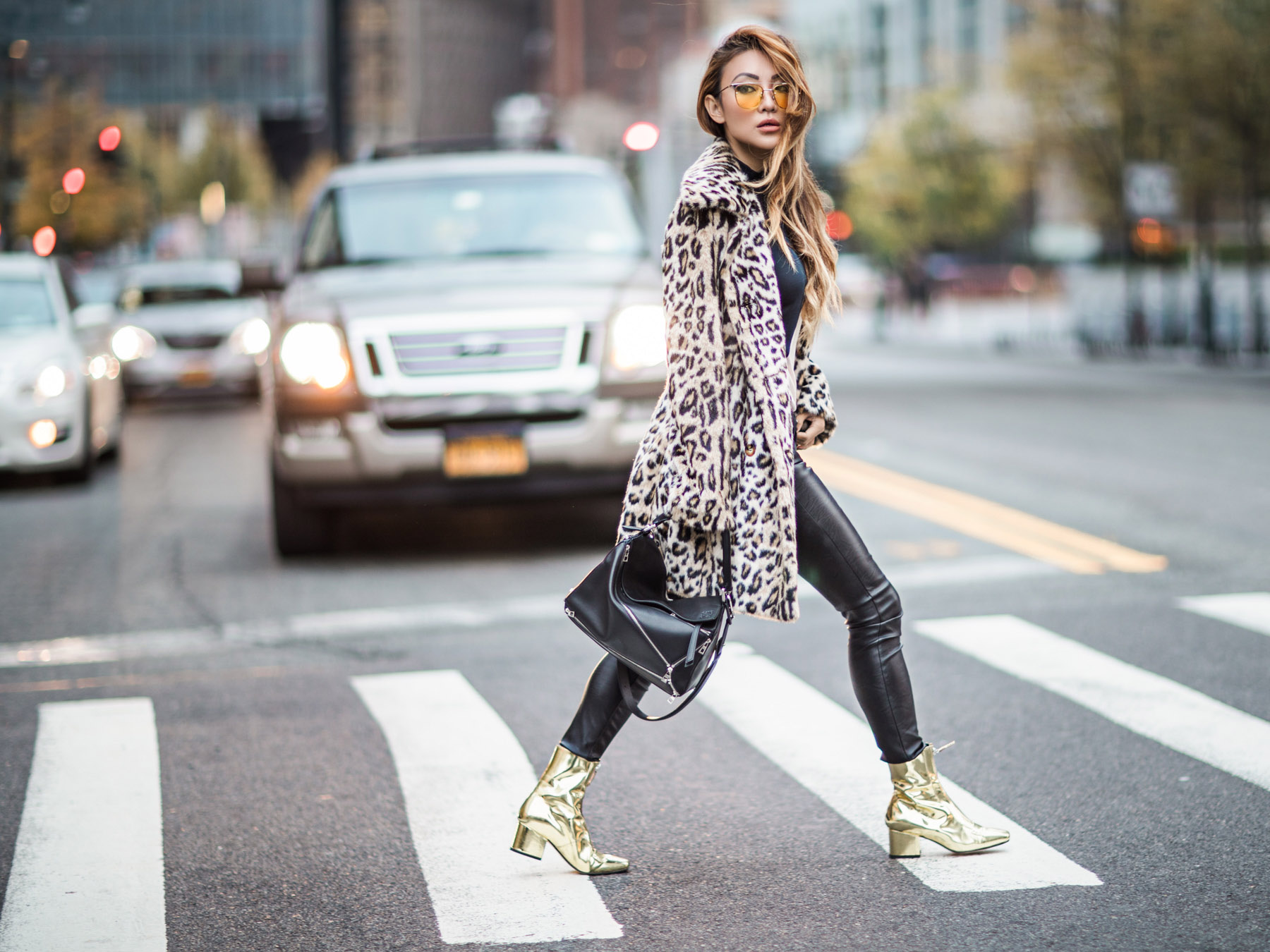 Fashion blogger wearing a leopard print coat over a black outfit