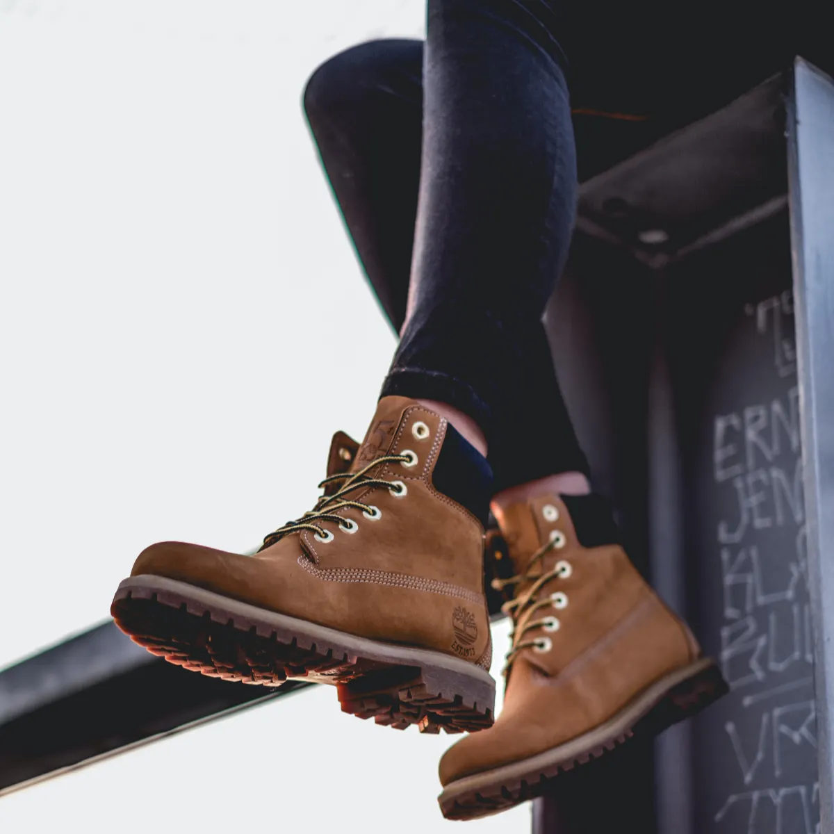 Close-up of wheat Timberland boots worn with cuffed dark jeans