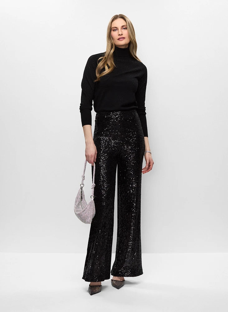 Woman wearing a black turtleneck sweater with sequin pants