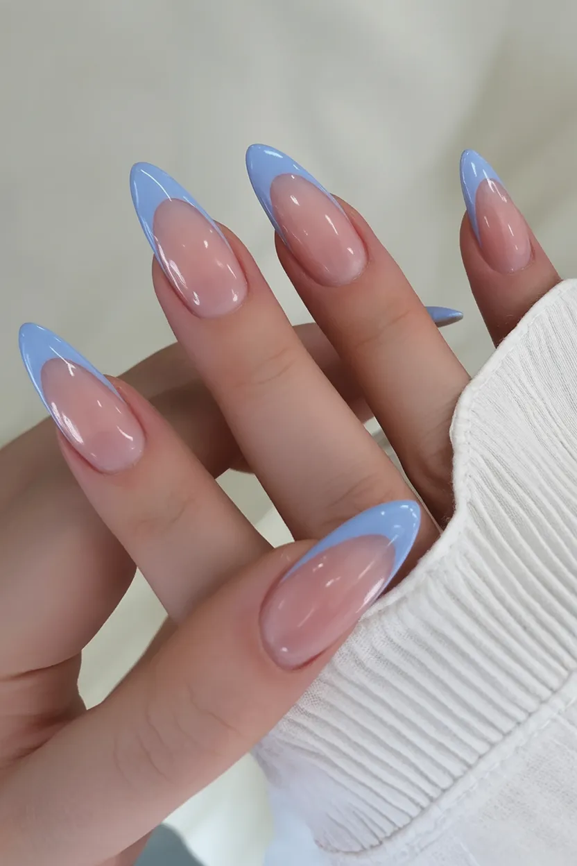 French tip nails with baby blue tips over a sheer nude base