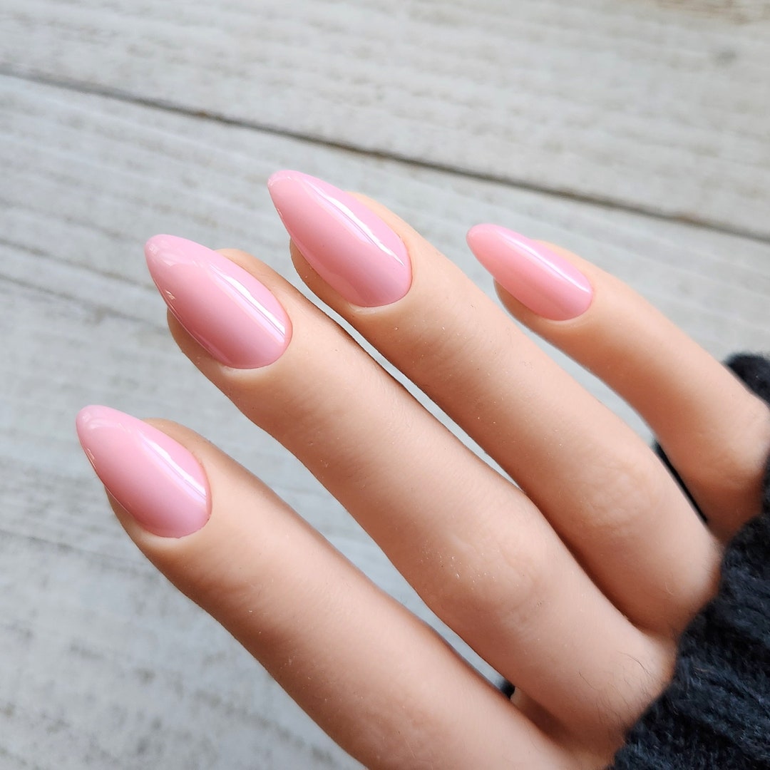Medium almond nails in milky sheer baby pink with a glossy jelly finish