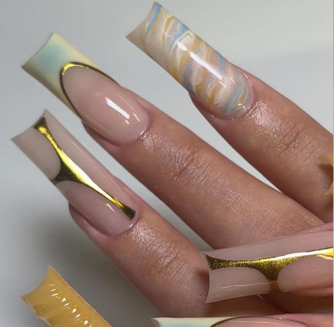 Gold chrome marble press-on nails with veined swirl design