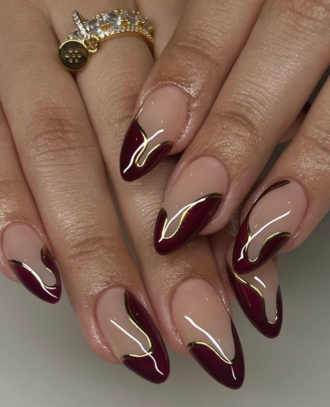 Wine red French tip press-on nails on almond shape