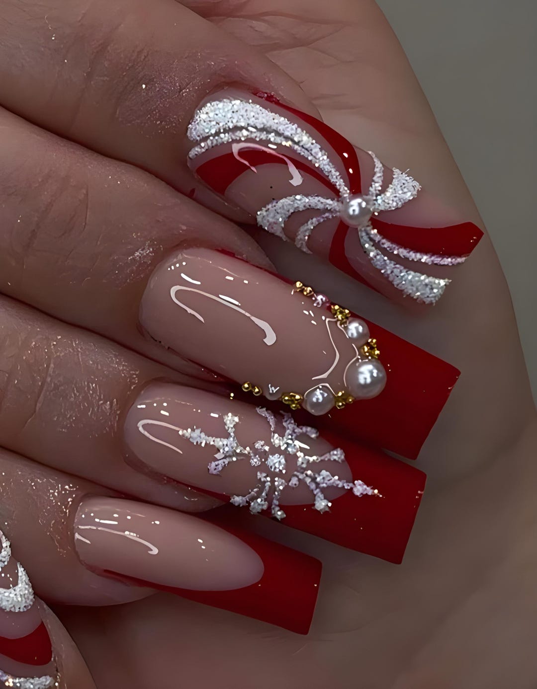 Nude short square nails with red French tips, glitter bow and pearls