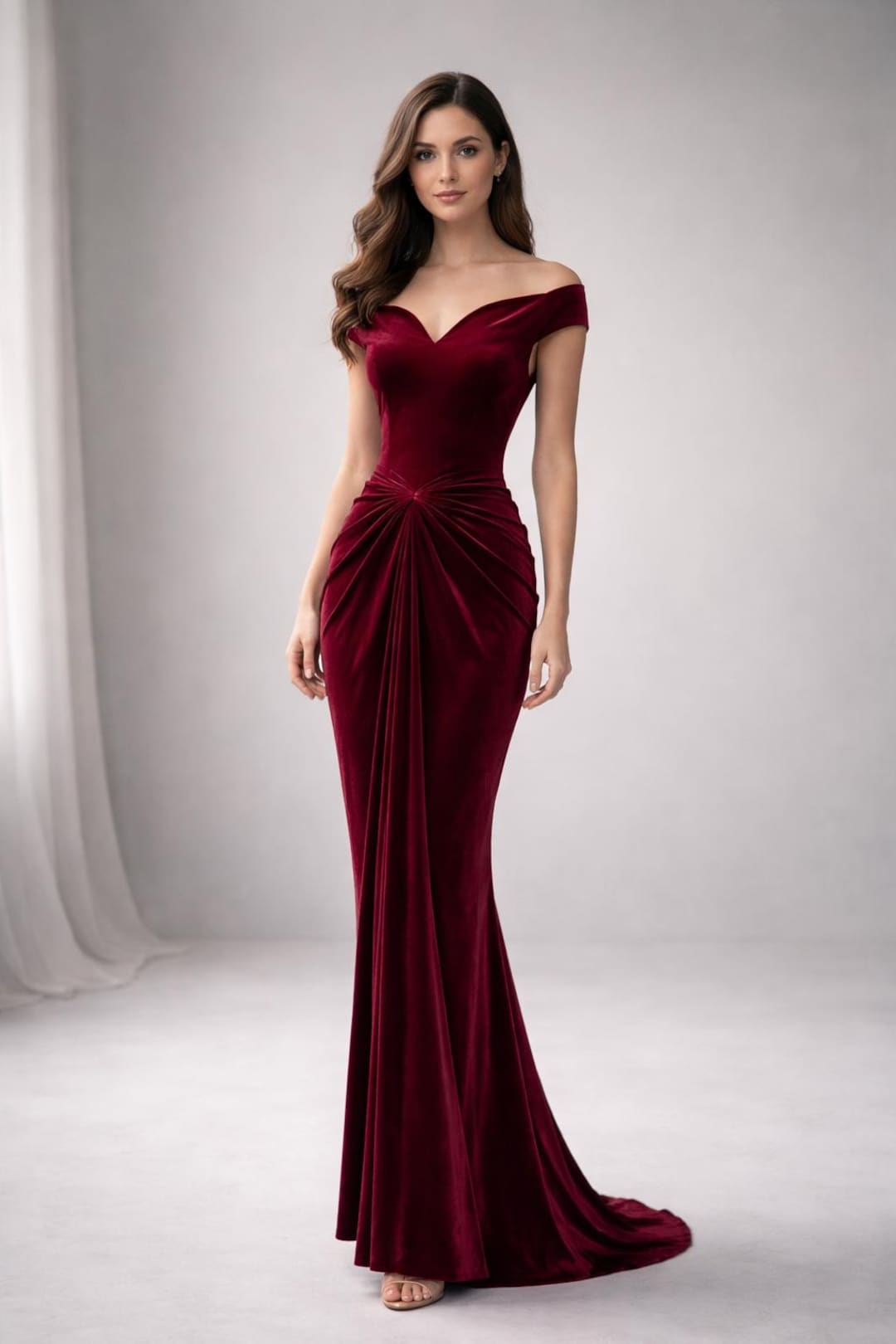Burgundy velvet evening gown on a dress form