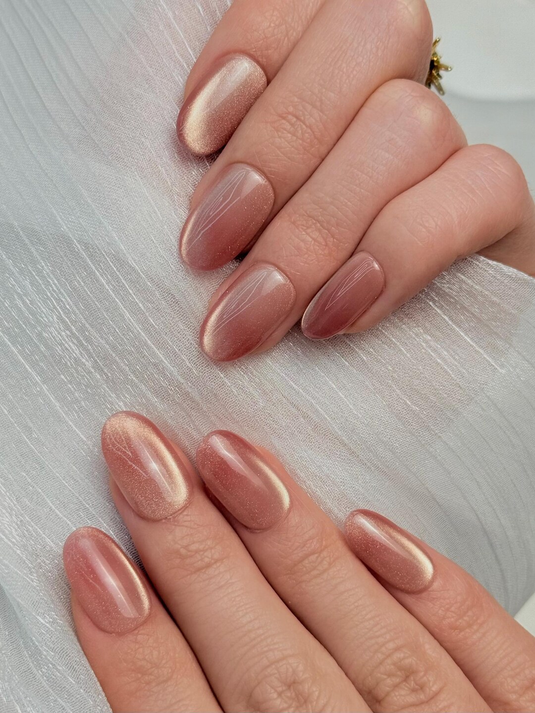 Dusty rose cat eye nails with golden shimmer