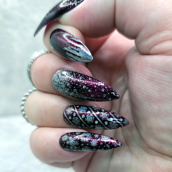Dark plum stiletto nails with holographic silver snowflakes and glitter