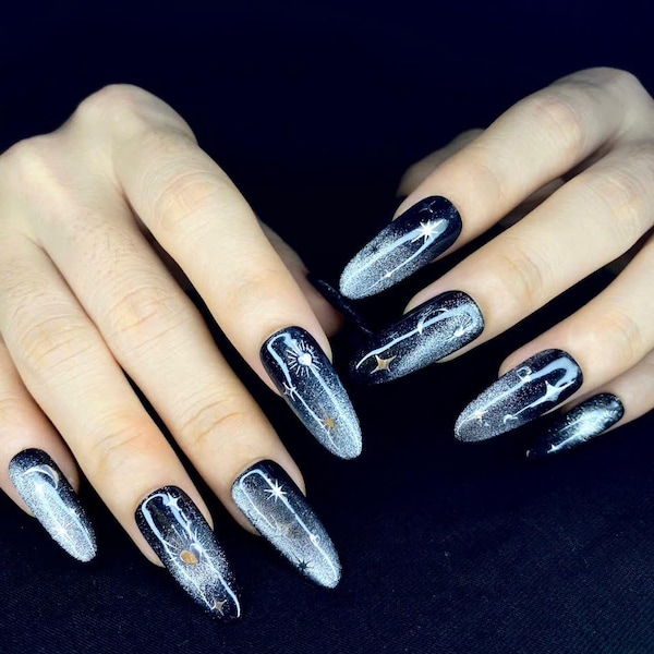 Black galaxy cat eye nails with multicolor shimmer