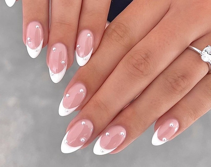 White French tip nails with tiny pearl accents