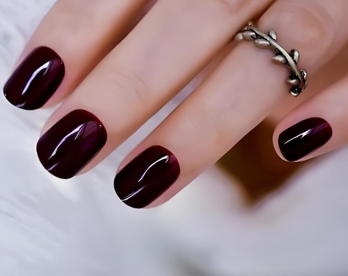 Short round nails in a glossy deep wine burgundy shade