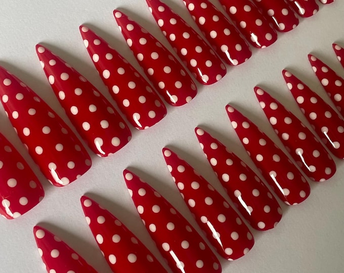 Cherry red press-on nails with white polka dot accents