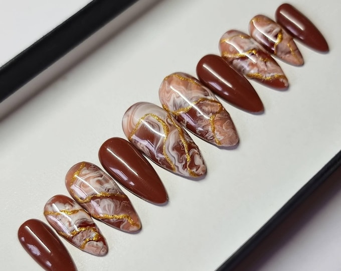 Brown marble press-on nails with swirling stone pattern