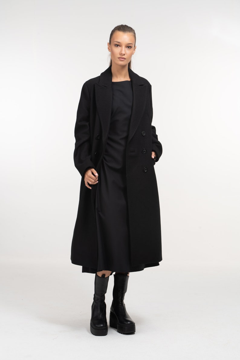 Long black double-breasted wool coat, a Scandinavian minimalist outerwear piece