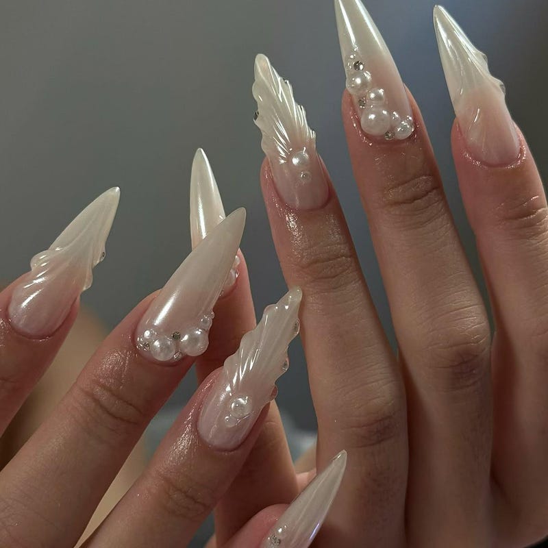 Ivory pearlescent stiletto nails with pearl and crystal clusters