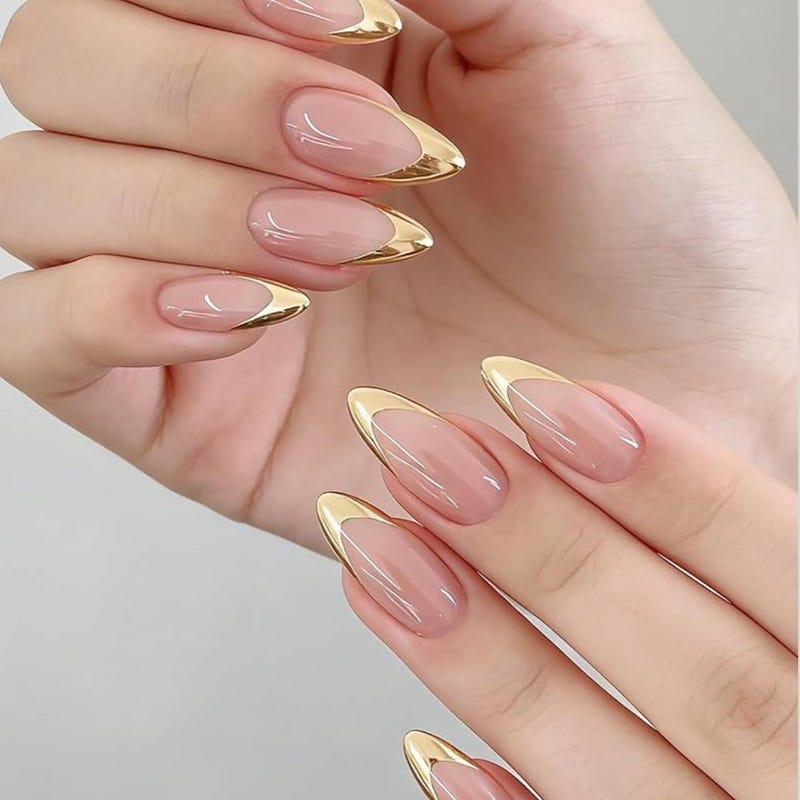 Nude almond nails with metallic gold french tips