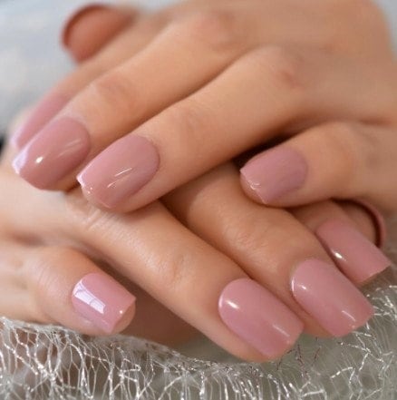 Short rounded nails in dusty rose mauve pink polish