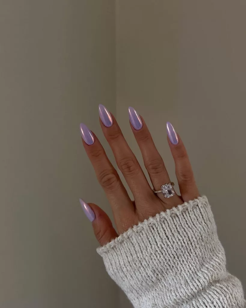Almond nails in pale lilac polish with a pearly chrome glazed finish