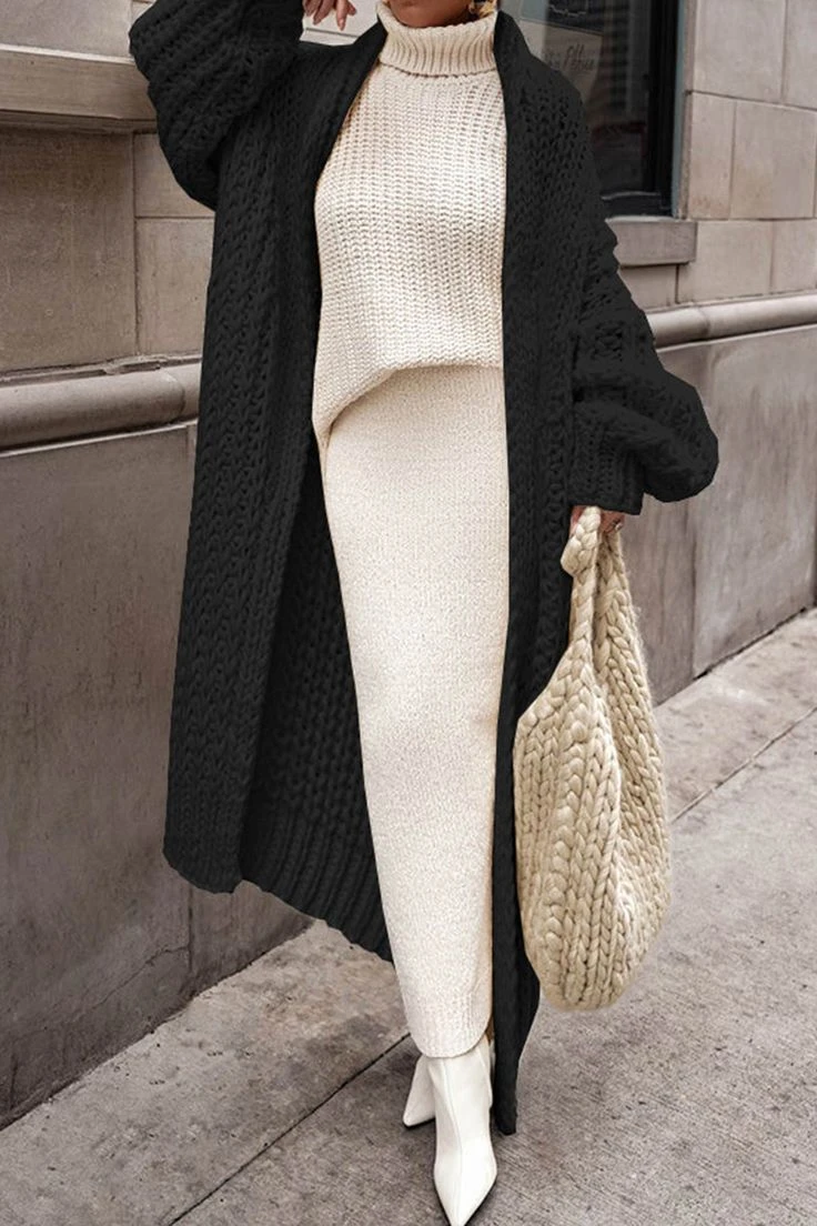 Woman in an oversized chunky knit cardigan outfit from a winter fashion editorial