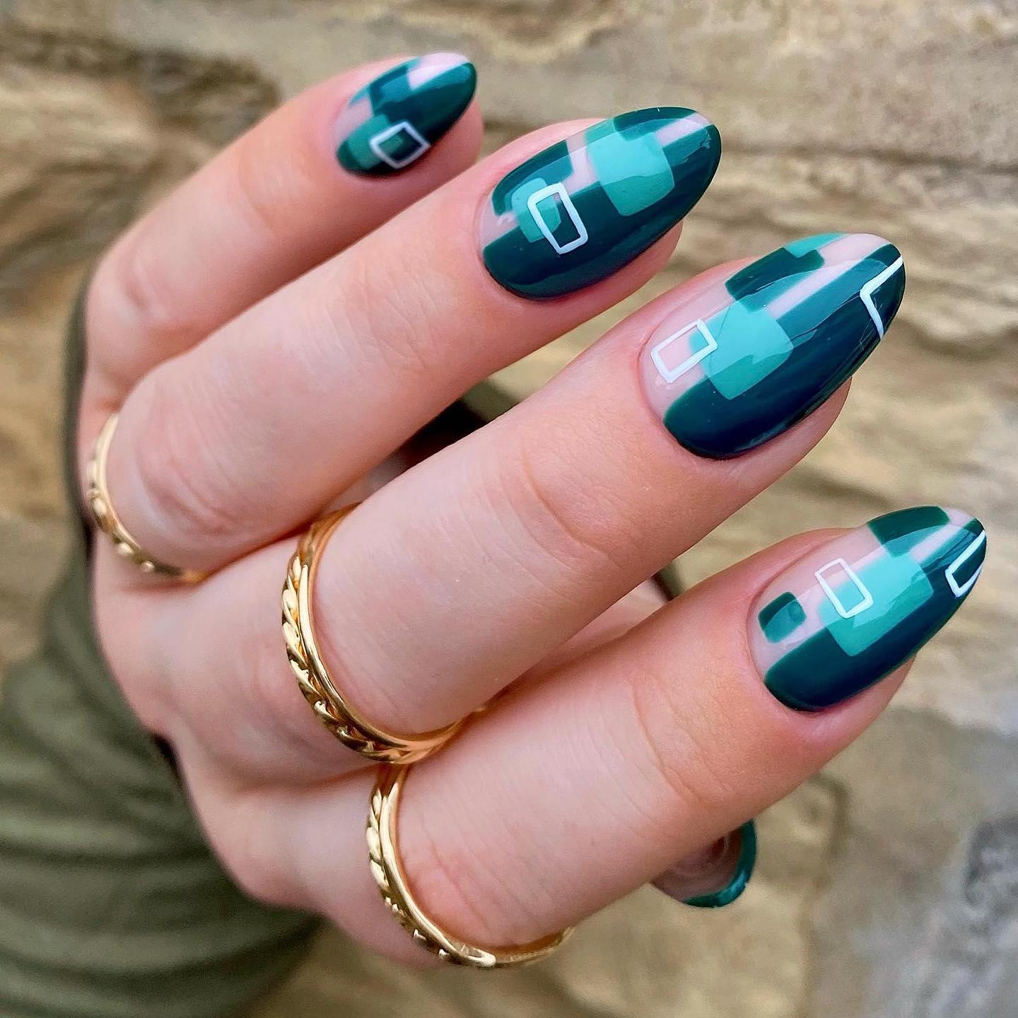 Geometric color-block nails in emerald green and nude