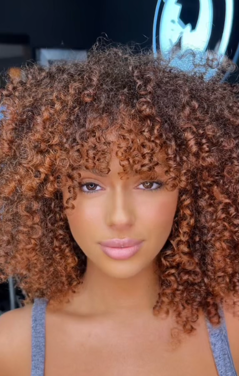 Vibrant ginger on coily curly hair