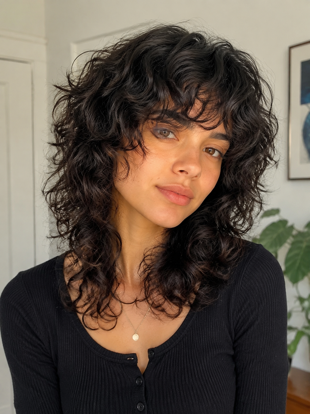 Long dark curly shag haircut with textured layers