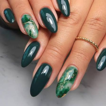 Almond nails in deep green with gold marbled foil accent nails