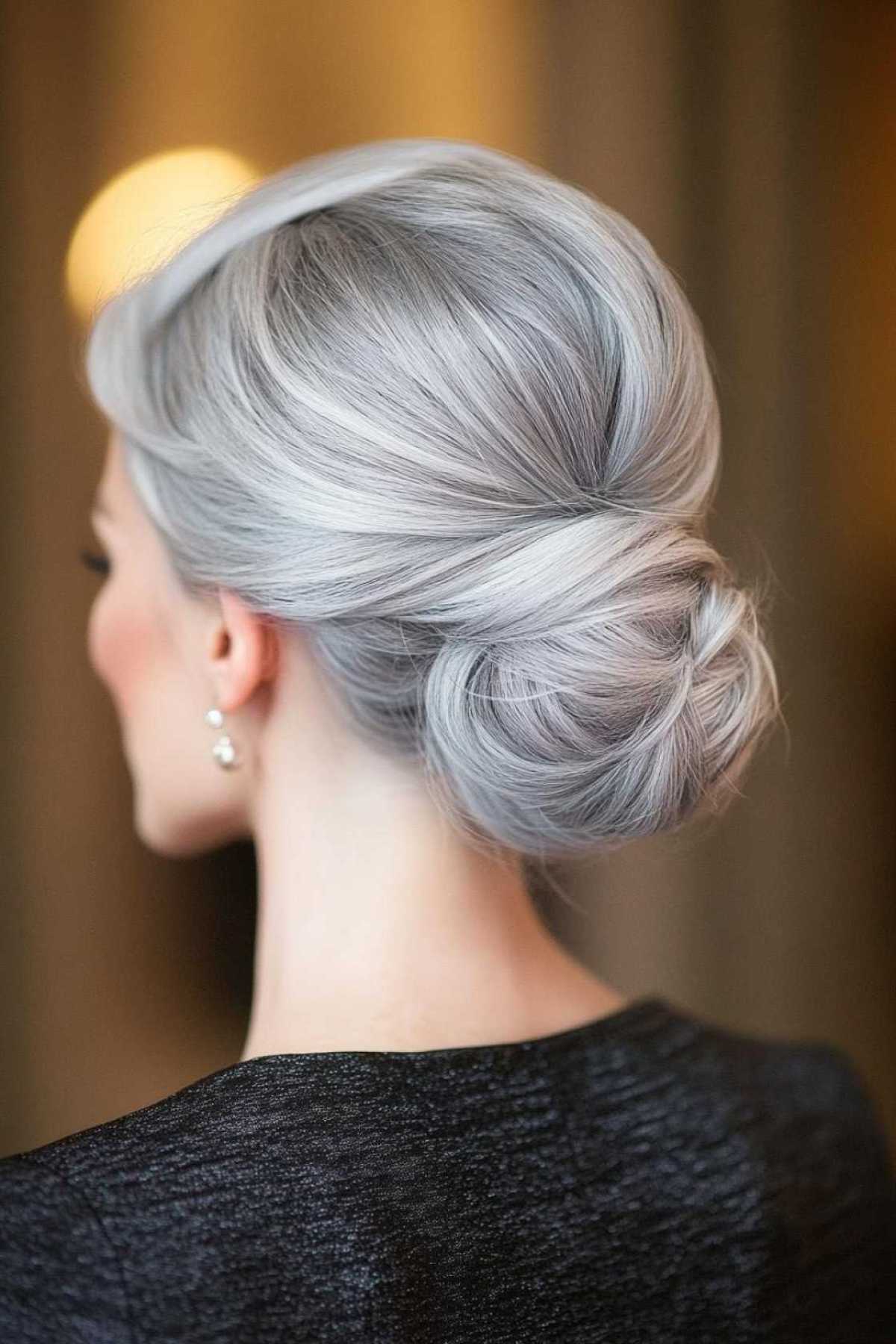 Back view of a polished silver chignon bun on gray hair