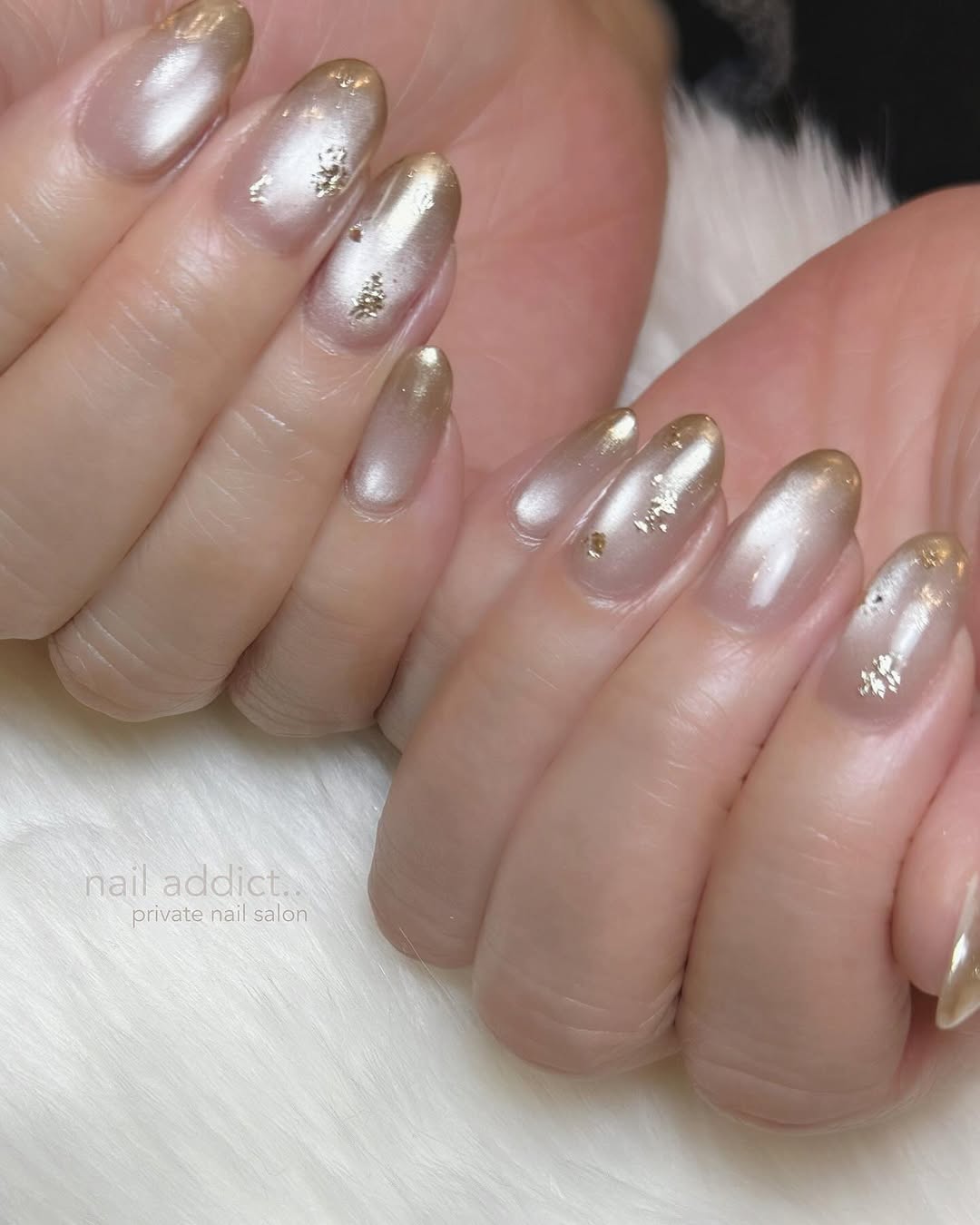 Satin Champagne: a frosted pearl-champagne ombré with gold-foil flakes on oval nails