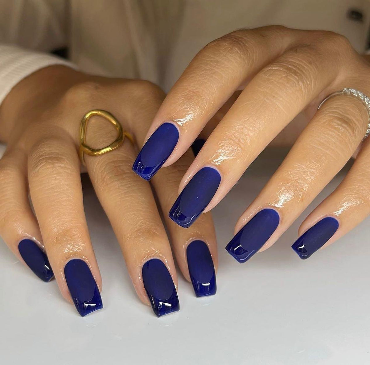 Medium square nails in matte navy with glossy navy French tips