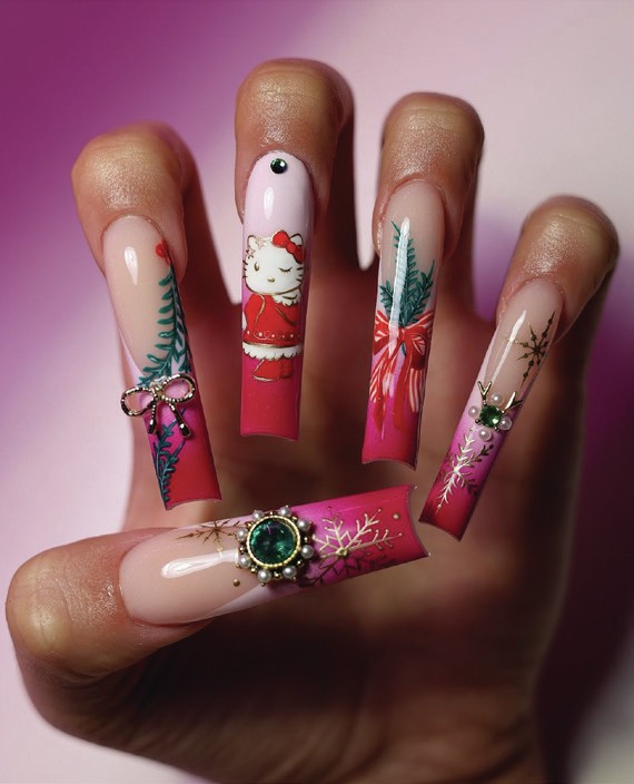 Long square nails with nude to hot pink ombre, Hello Kitty in a red dress, Christmas tree branches and a large green gemstone cluster