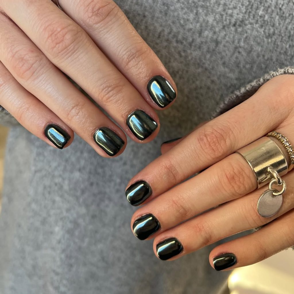 Short squoval nails with dark green-black chrome mirror finish