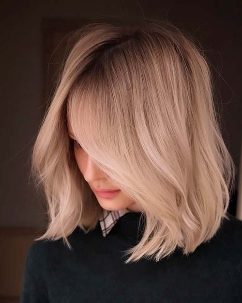 Wavy platinum blonde lob with smoky shadow root lowlights