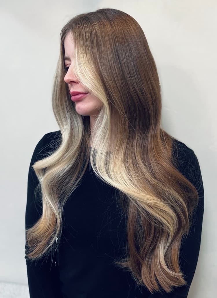 Dimensional brunette long hair with bold blonde face-framing highlights
