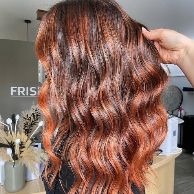 Cowboy copper hair color on long wavy hair