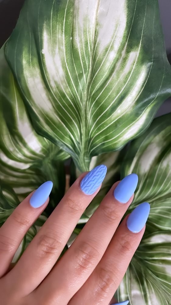 Matte periwinkle blue almond nails with a cable-knit accent nail