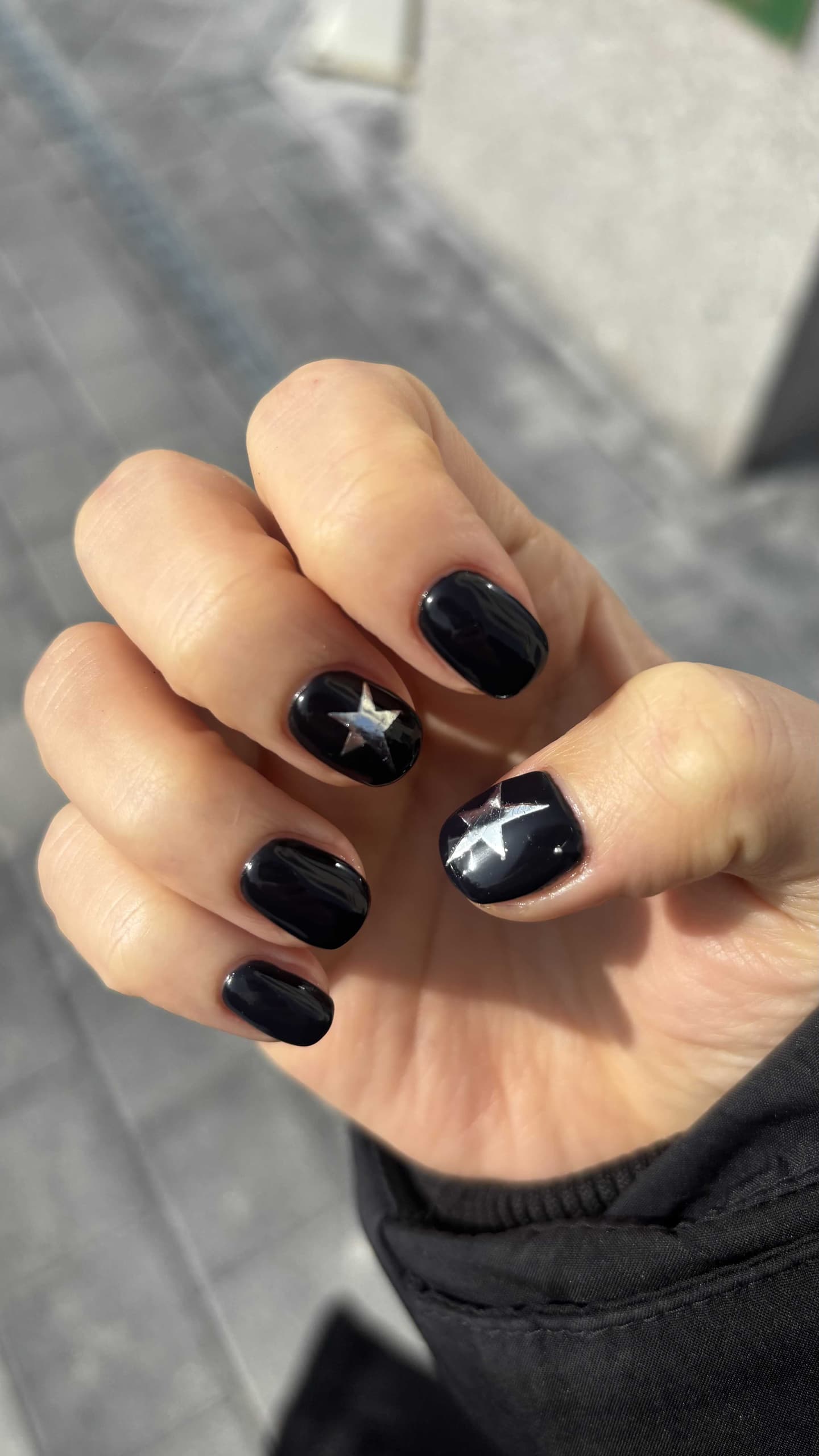 Short black nails with silver star nail art