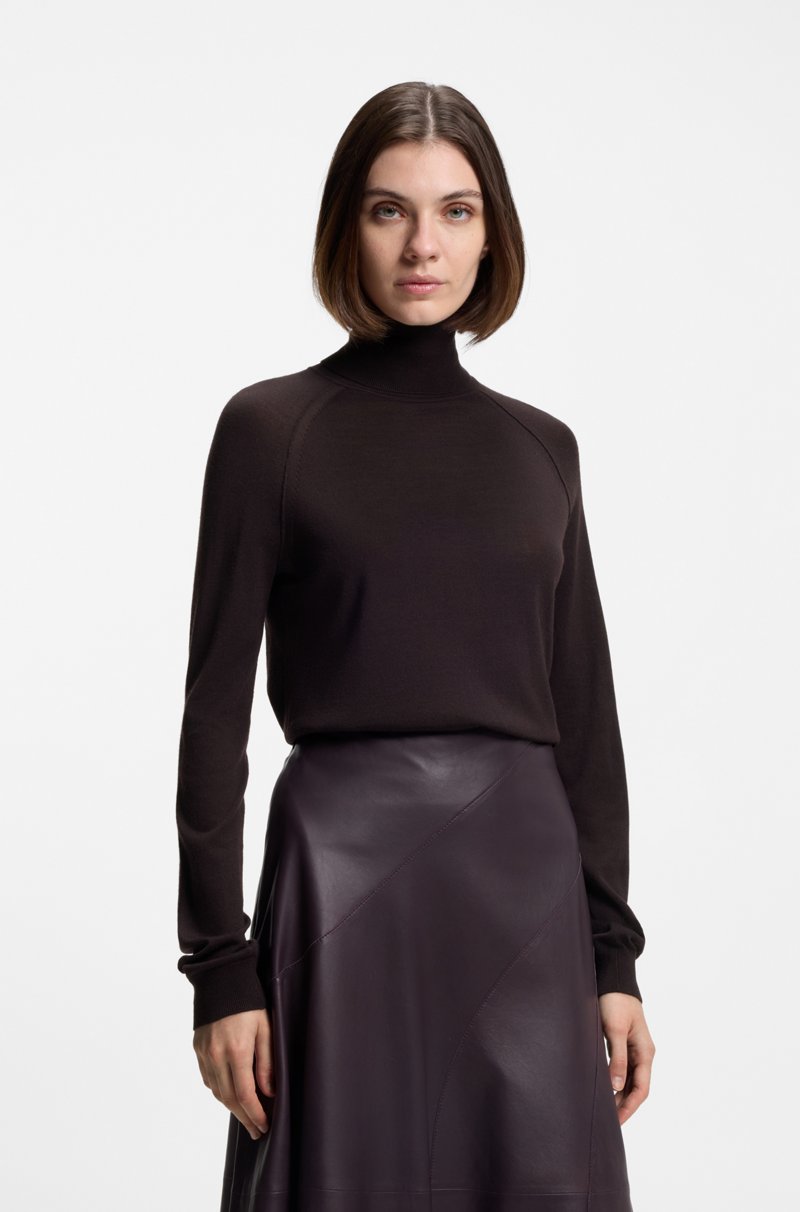 Model in dark chocolate turtleneck with plum leather A-line midi skirt