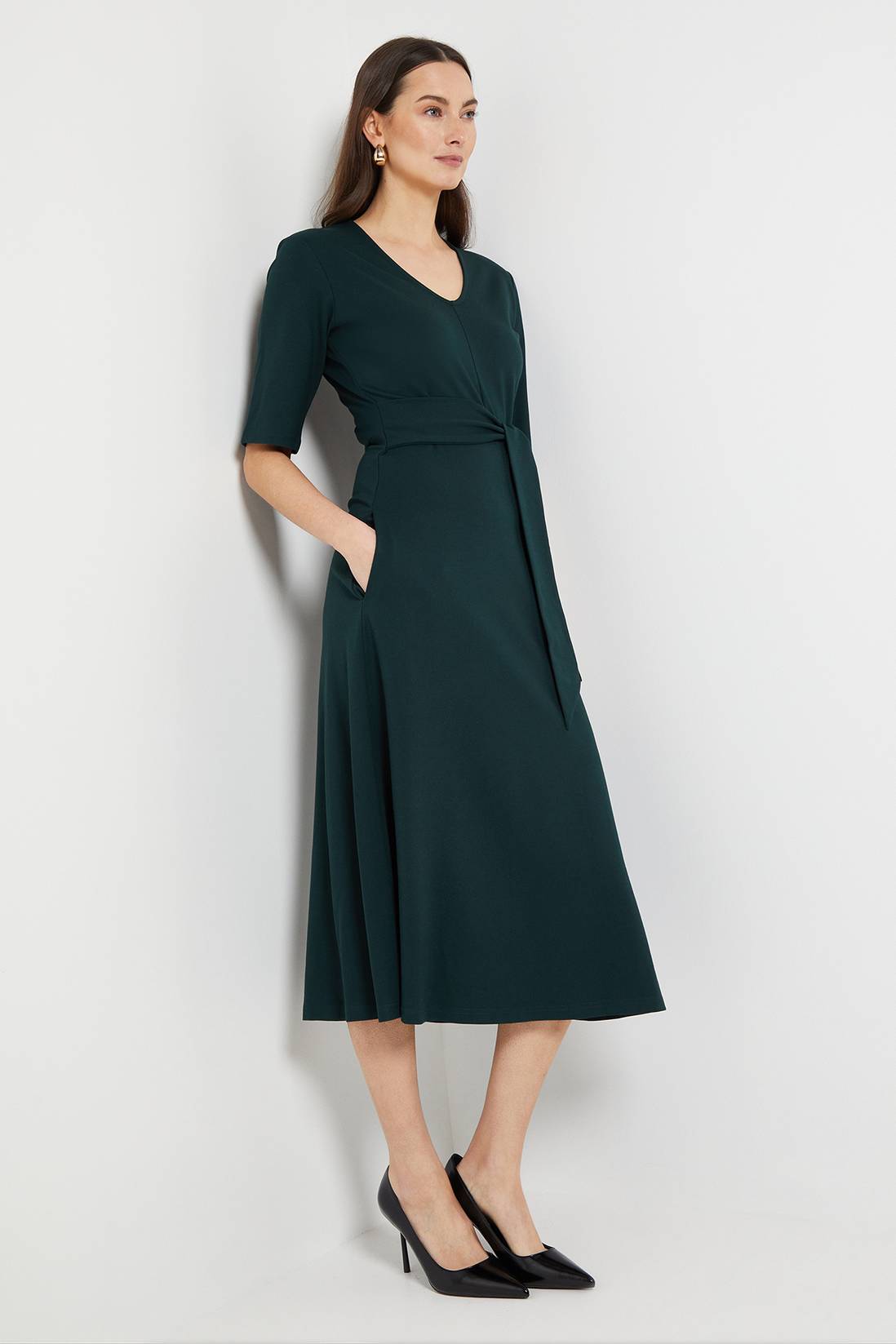 Forest green wrap midi dress with gold accessories