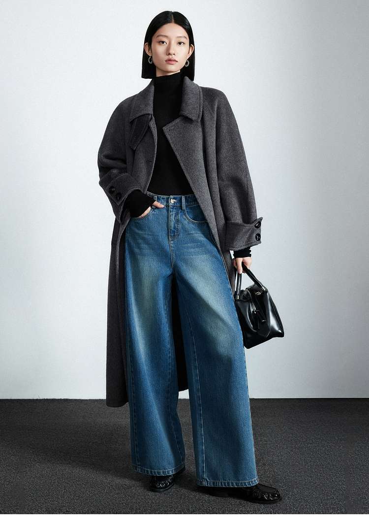 Winter outfit with a grey wool coat worn over a dark turtleneck and jeans