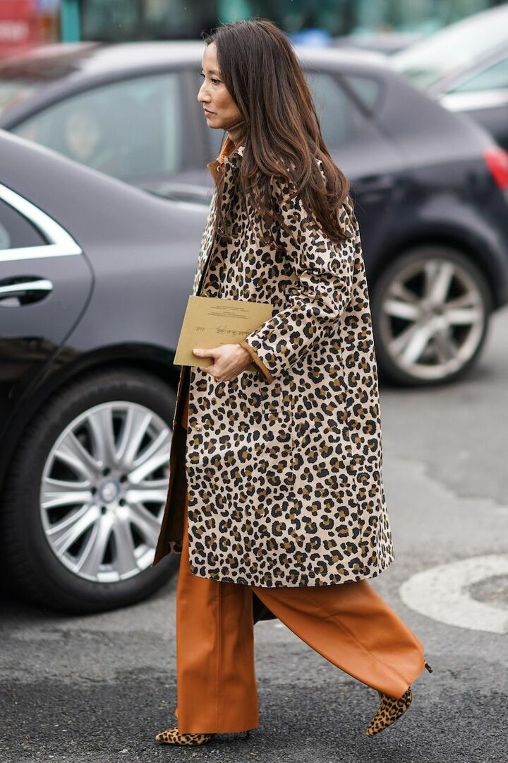 Leopard coat styled with refined neutral pieces, editorial fashion photo