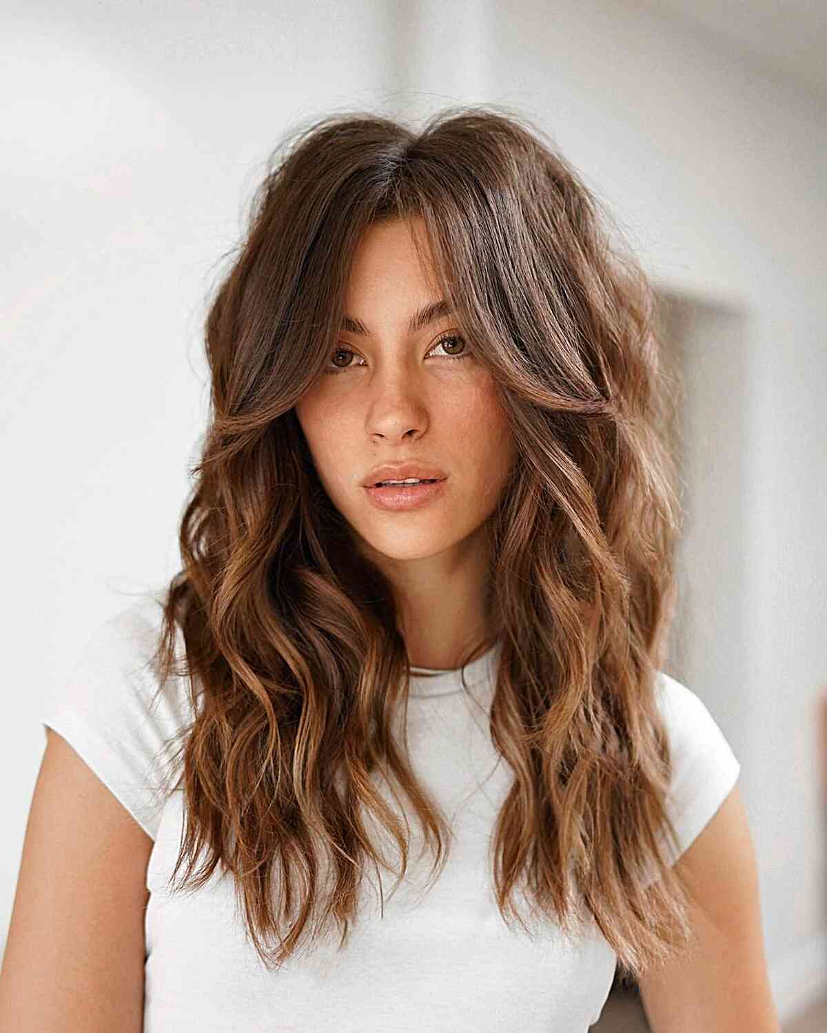 Collarbone-length shag with curtain fringe and internal layers