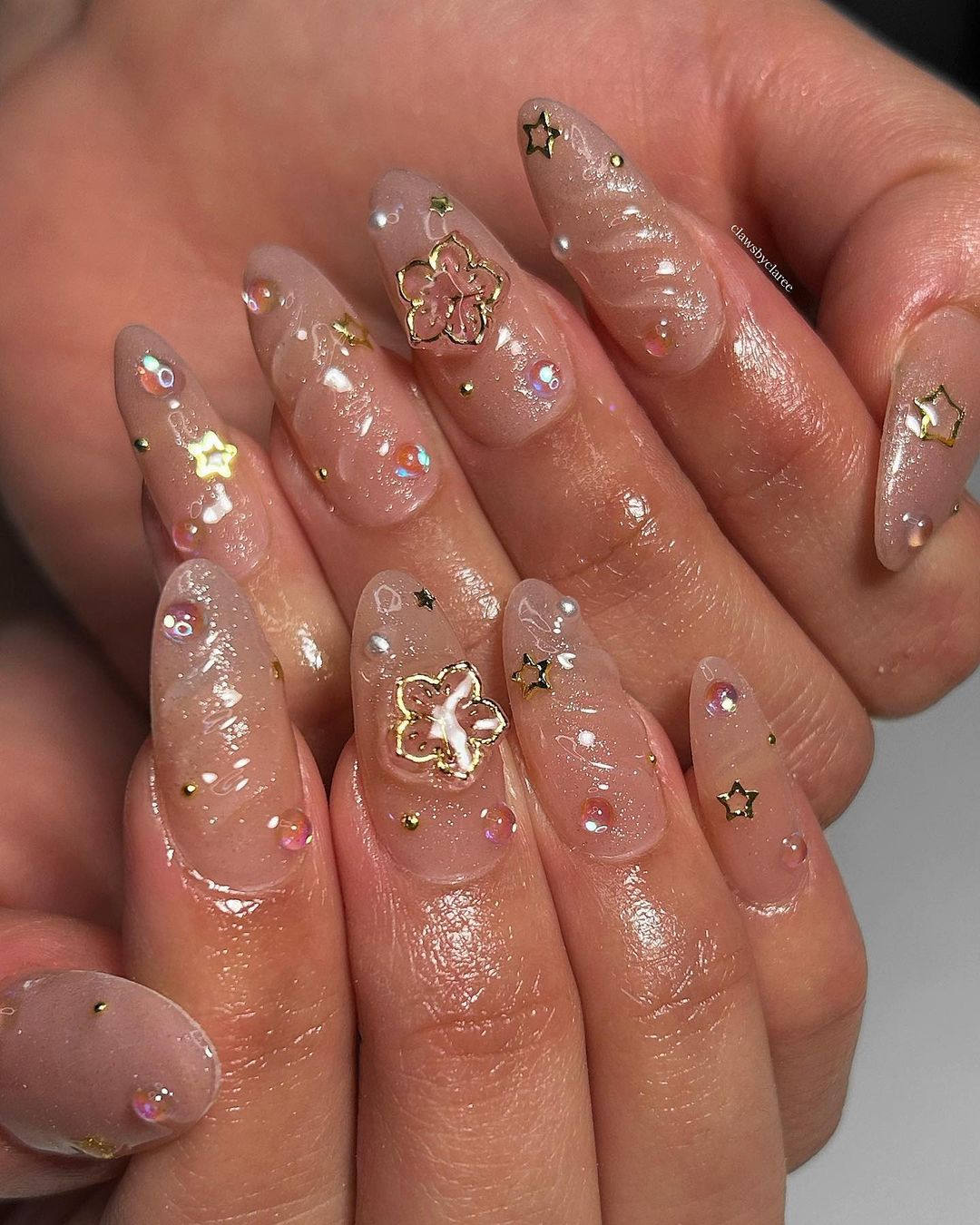Clear jelly nails with gold star charms, long almond