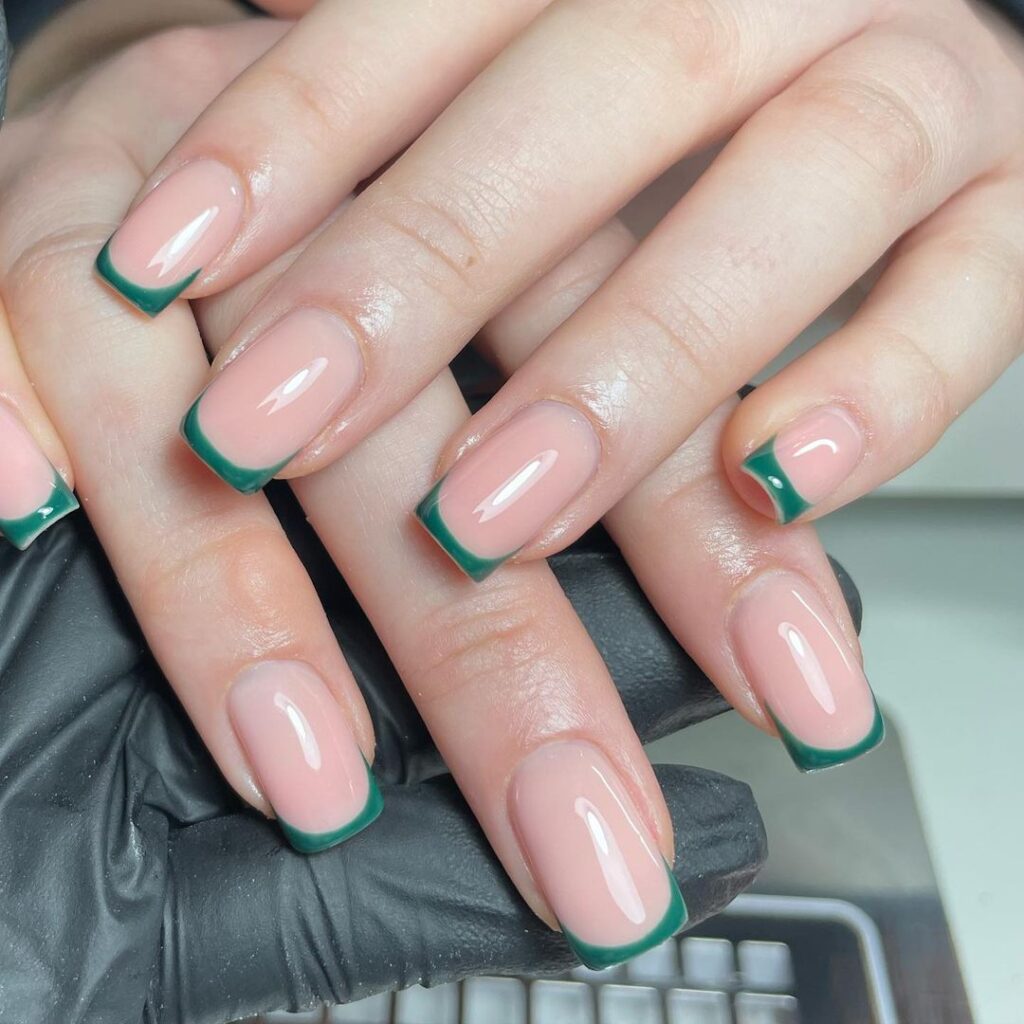 Nude square nails with forest green French tips