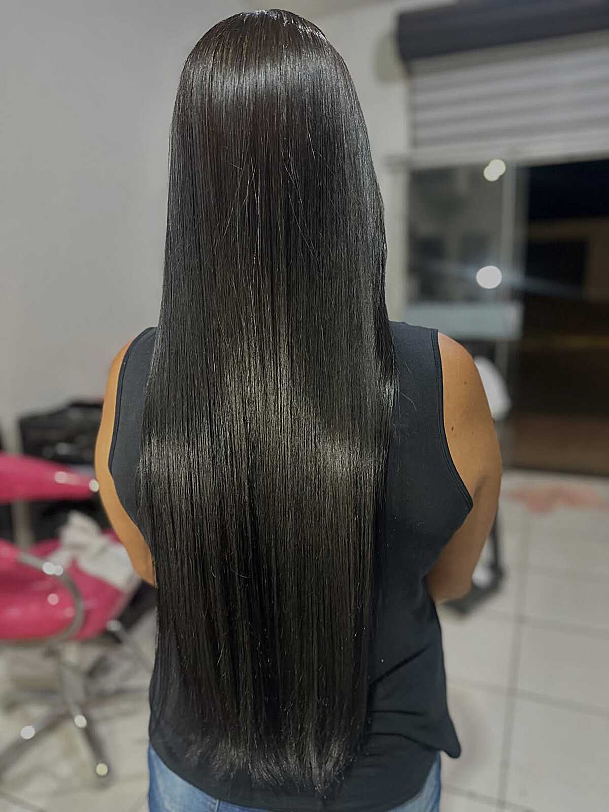 Waist-length straight jet black hair with mirror glass shine