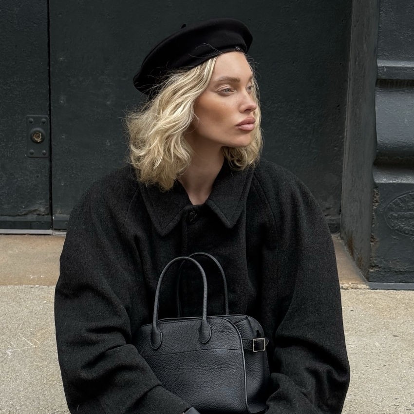Black beret embellished with pearls and a jeweled brooch