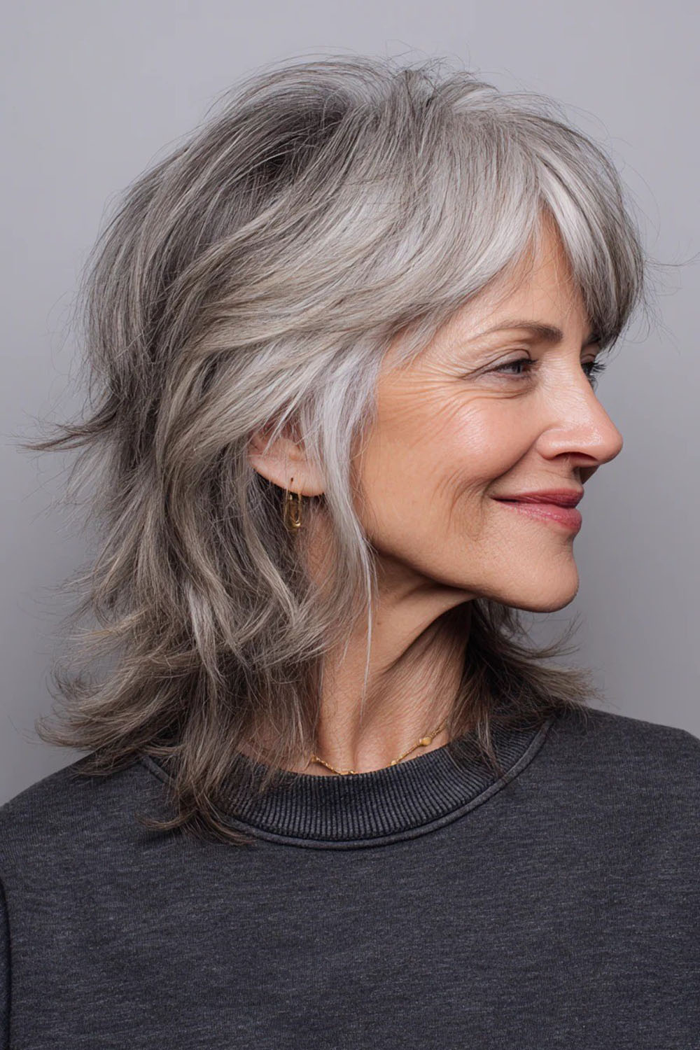 Medium length silver layered haircut with soft side swept pieces