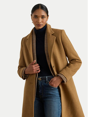 Woman wearing a camel wool coat with checkered trim over a black turtleneck and jeans