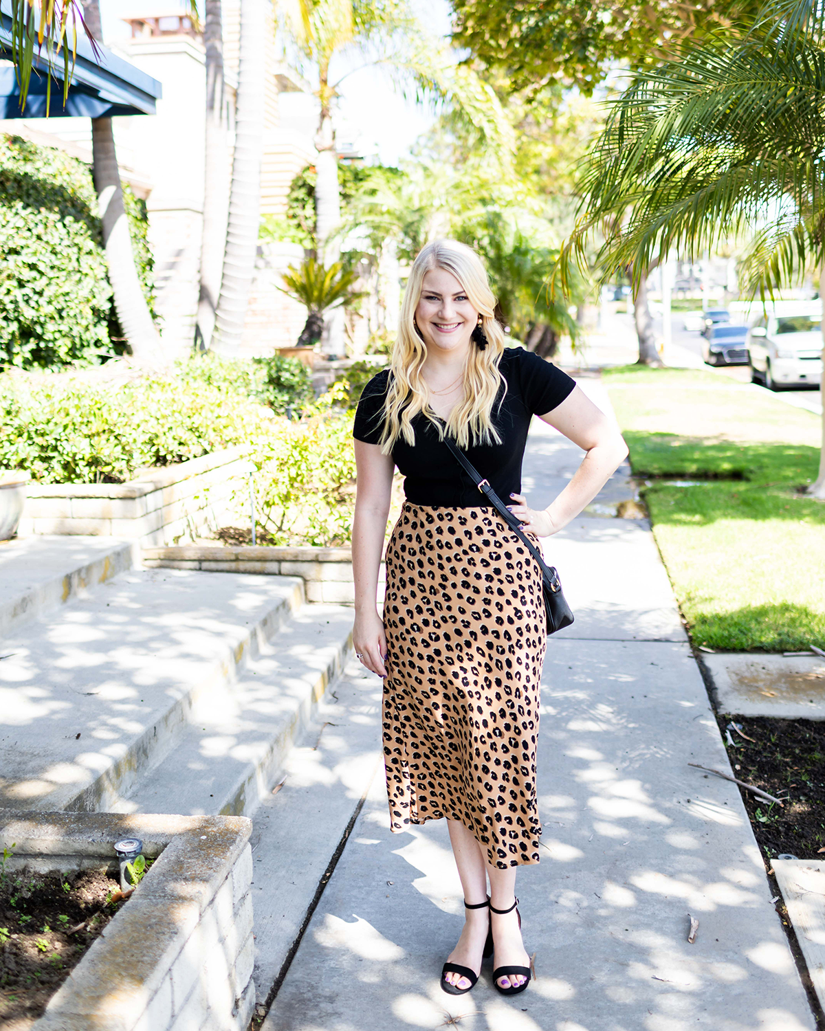 Woman wearing a leopard print midi skirt with a black top