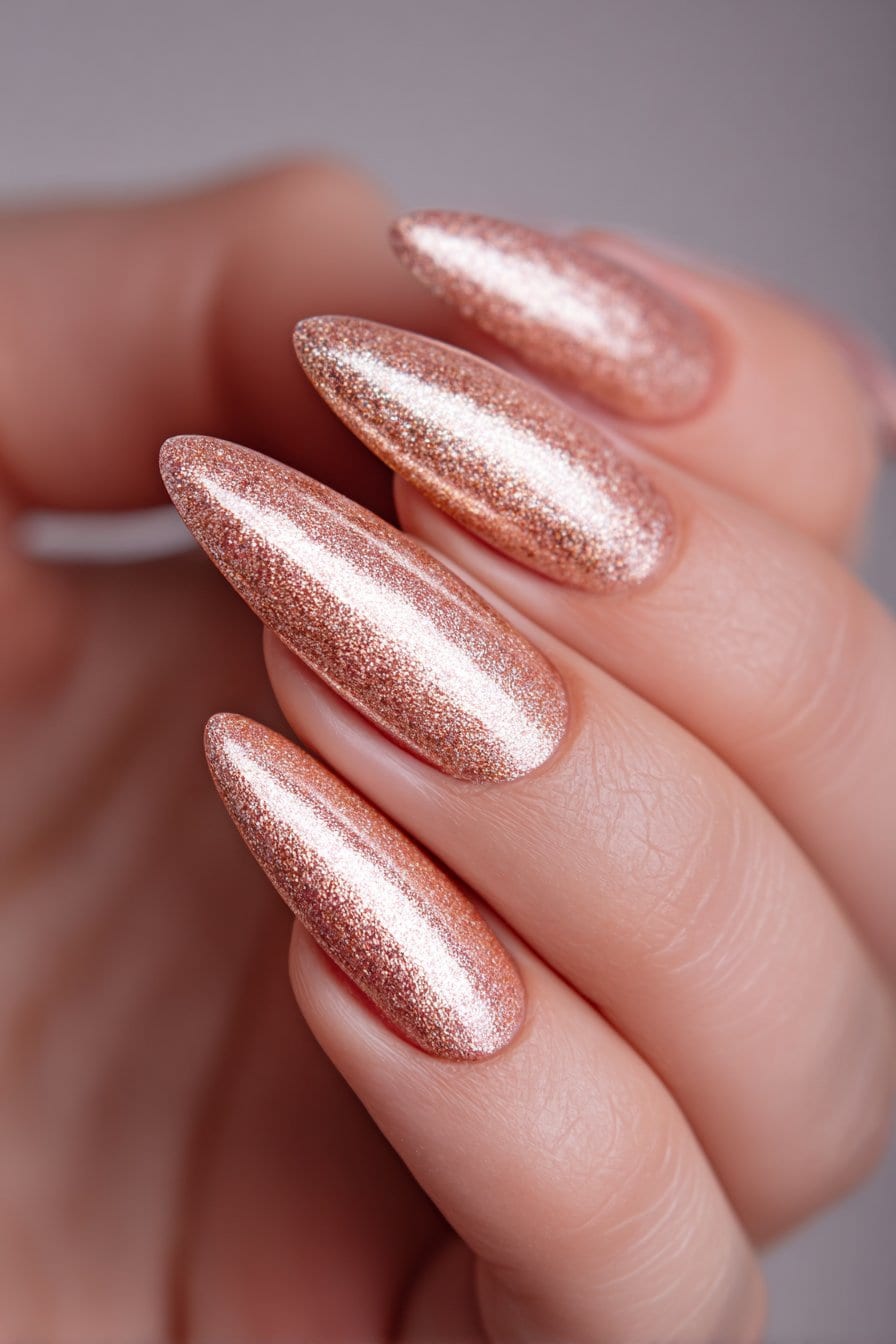 Long stiletto nails in shimmering rose gold glitter